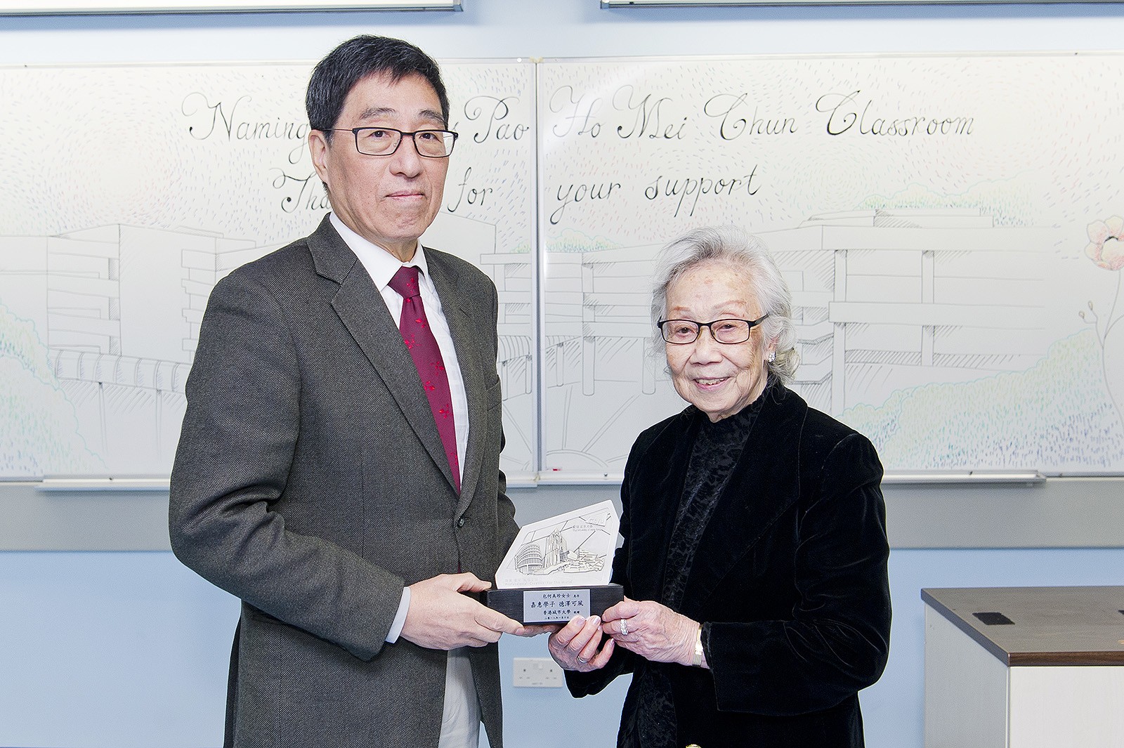 The President (left) presents souvenir to Mrs Pao (right).