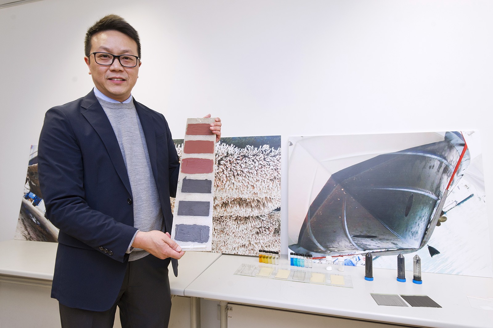 Professor Michael Leung shows the eco-friendly antifouling paint in his research.