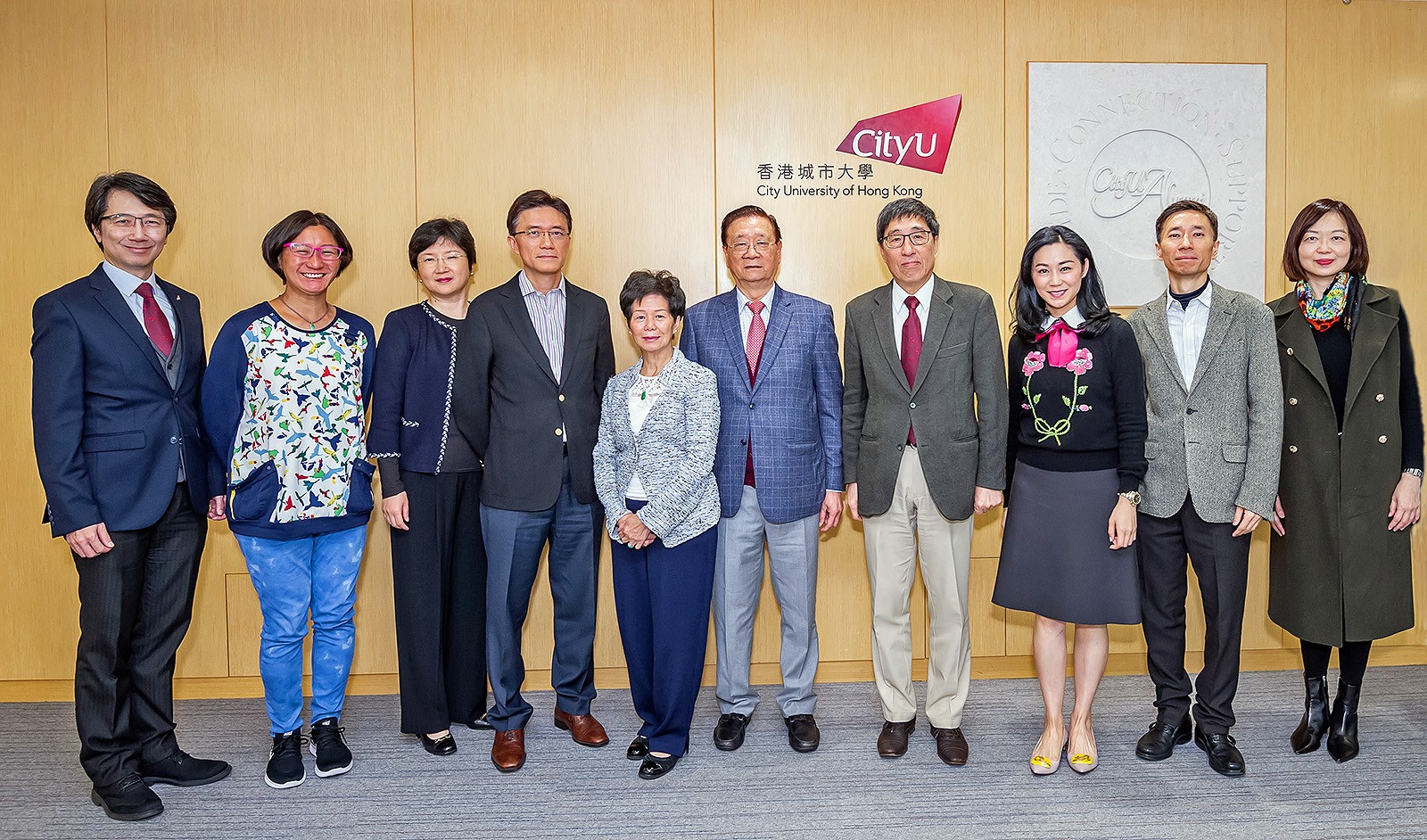 Mr and Mrs Chu, their family members and CityU senior management at the cheque presentation ceremony.